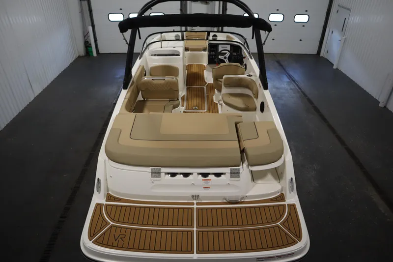Slide: The Image of 2025 Bayliner VR6 Bowrider OB with spacious seating and modern design in a showroom. - 9
