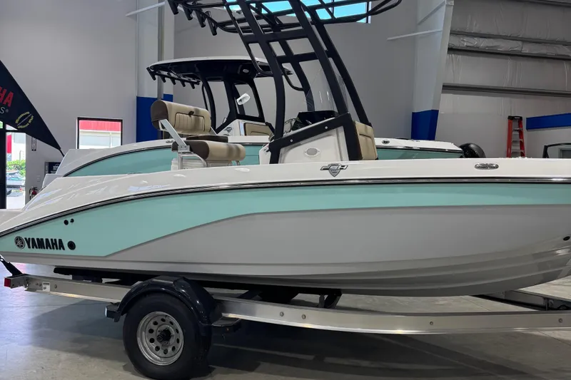The Image of 2024 Yamaha Boats 190 FSH Sport in showroom, featuring sleek design and modern features. - 0