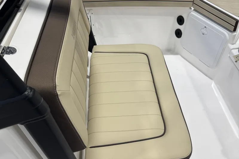 Slide: The Image of 2024 Yamaha Boats 190 FSH Sport interior seating, beige and brown upholstery. - 10