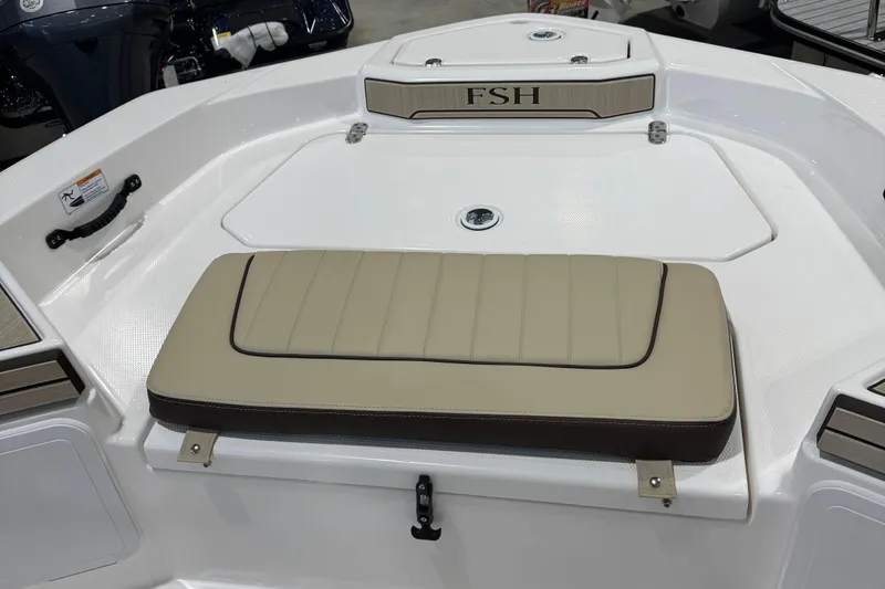 Slide: The Image of 2024 Yamaha Boats 190 FSH Sport bow seating area with beige cushion. - 14