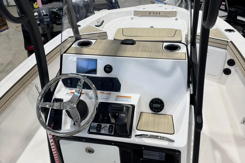 Slide: The Image of 2024 Yamaha Boats 190 FSH Sport dashboard with steering wheel and controls. - 4