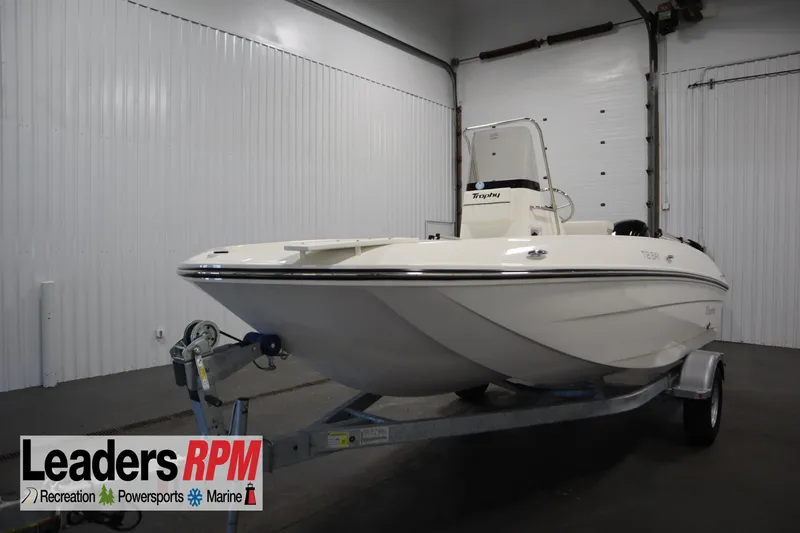 Slide: The Image of 2026 Bayliner Trophy T18 boat on trailer in indoor showroom. - 0