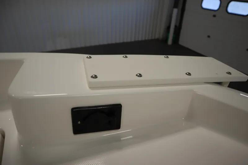 Slide: The Image of 2026 Bayliner Trophy T18 boat interior detail with mounted panel and screws. - 11