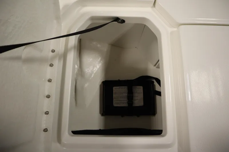 Slide: The Image of Storage compartment of 2026 Bayliner Trophy T18 boat with secured battery inside. - 14