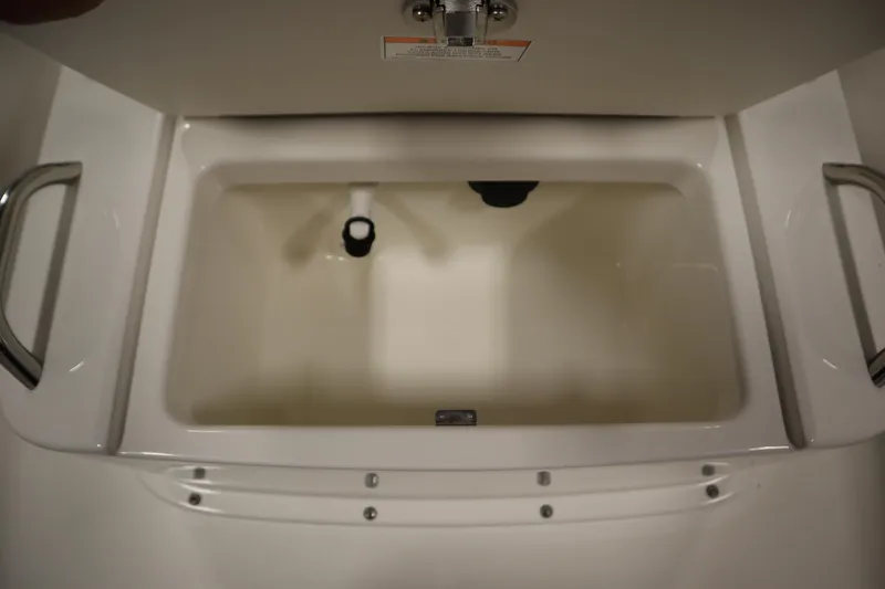 Slide: The Image of 2026 Bayliner Trophy T18 boat storage compartment with handles and drainage system. - 16