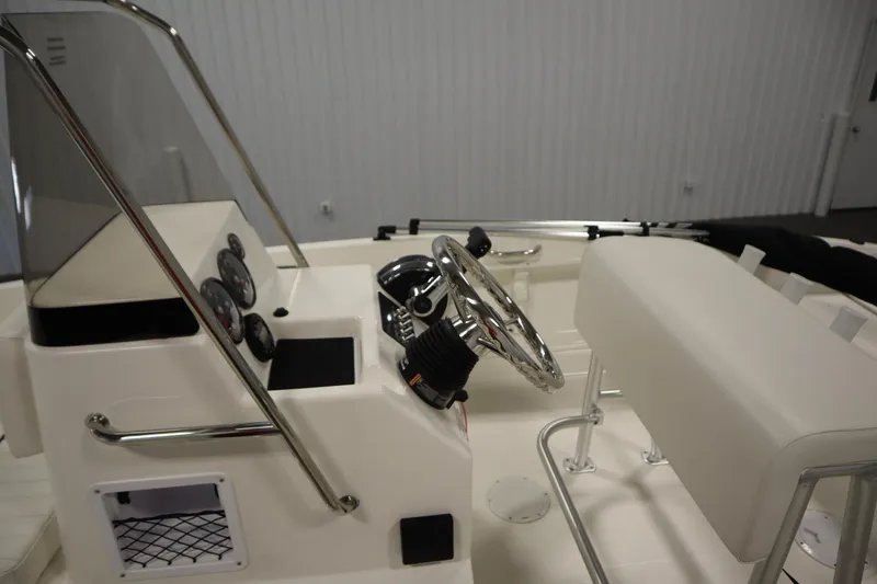 Slide: The Image of 2026 Bayliner Trophy T18 boat interior with steering wheel and dashboard controls. - 20