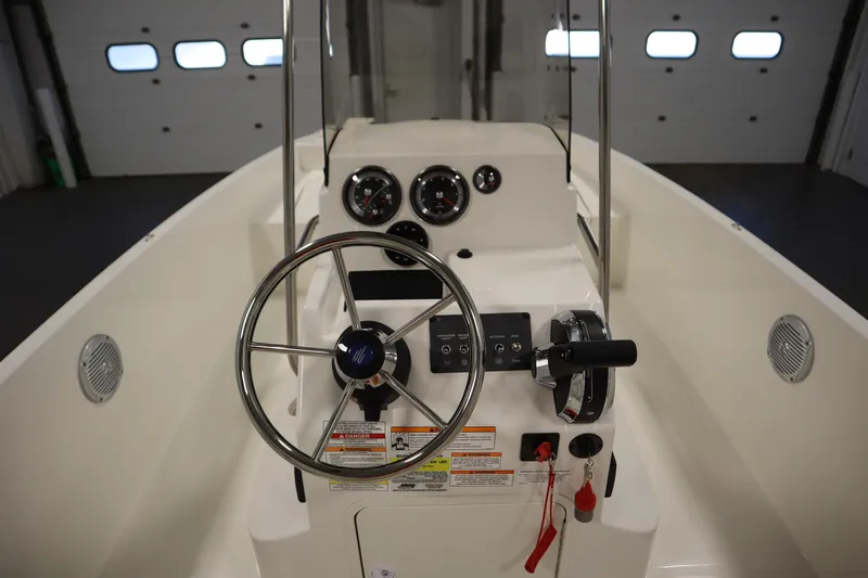 Slide: The Image of 2026 Bayliner Trophy T18 boat dashboard with steering wheel and control panel. - 21