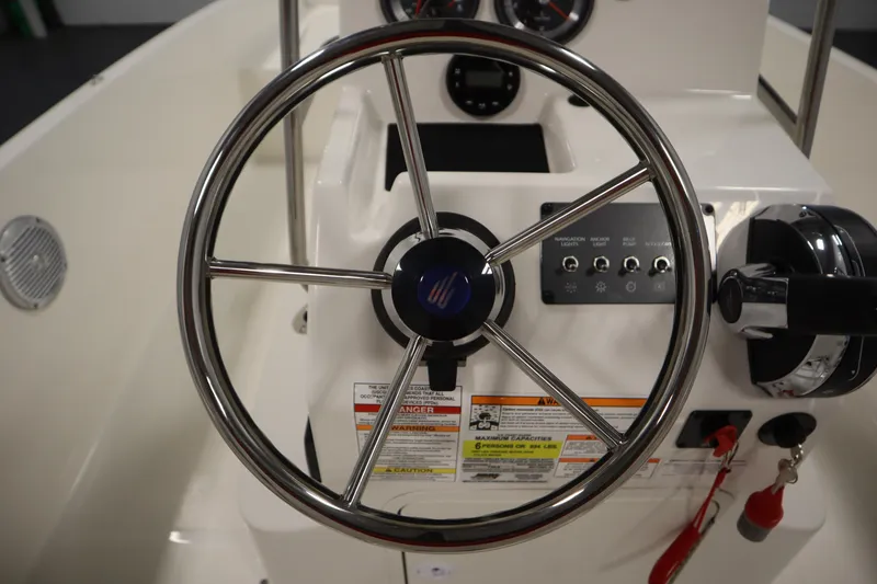 Slide: The Image of 2026 Bayliner Trophy T18 steering wheel and control panel close-up. - 22