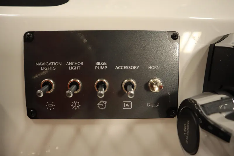 Slide: The Image of Control panel of 2026 Bayliner Trophy T18 with switches for lights, bilge pump, and horn. - 24