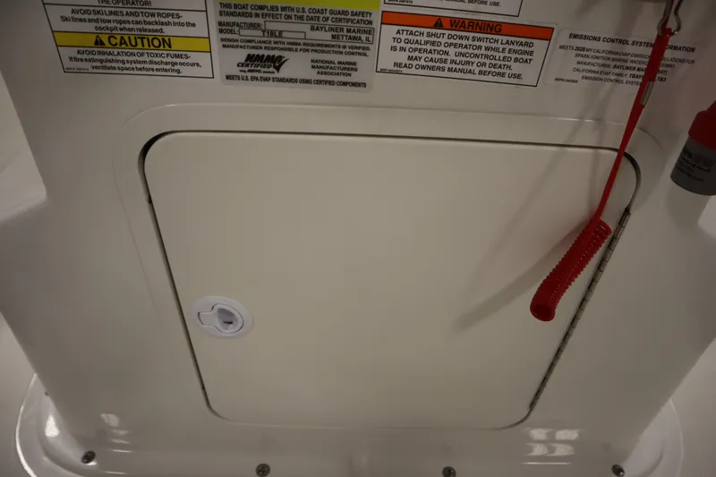 Slide: The Image of Access panel on 2026 Bayliner Trophy T18 boat with safety warnings and red lanyard. - 26