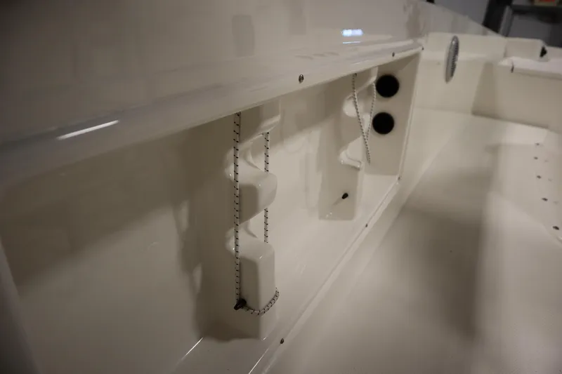 Slide: The Image of 2026 Bayliner Trophy T18 interior detail with storage compartments and fixtures. - 31