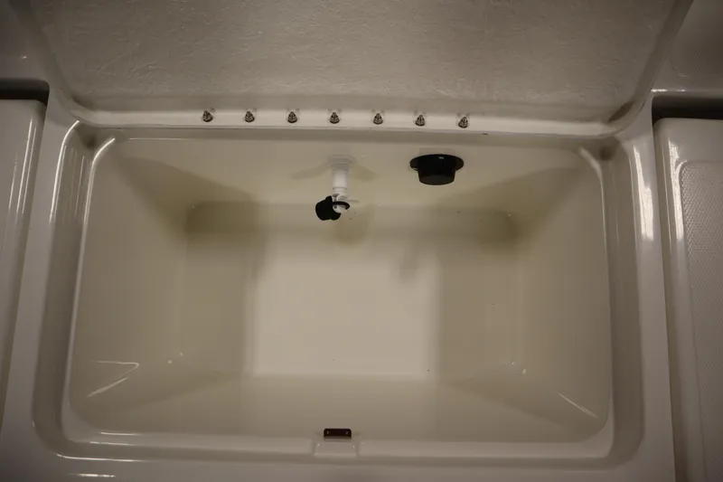 Slide: The Image of 2026 Bayliner Trophy T18 livewell with drainage and lid, ideal for fishing trips. - 34