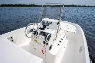 Slide: The Image of 2026 Bayliner T18 LE boat interior with steering console on a calm lake. - 43