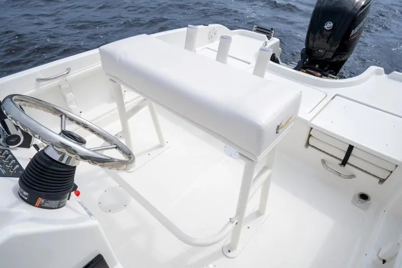Slide: The Image of Bayliner T18 LE 2026 boat interior with steering wheel and seating, on water. - 48