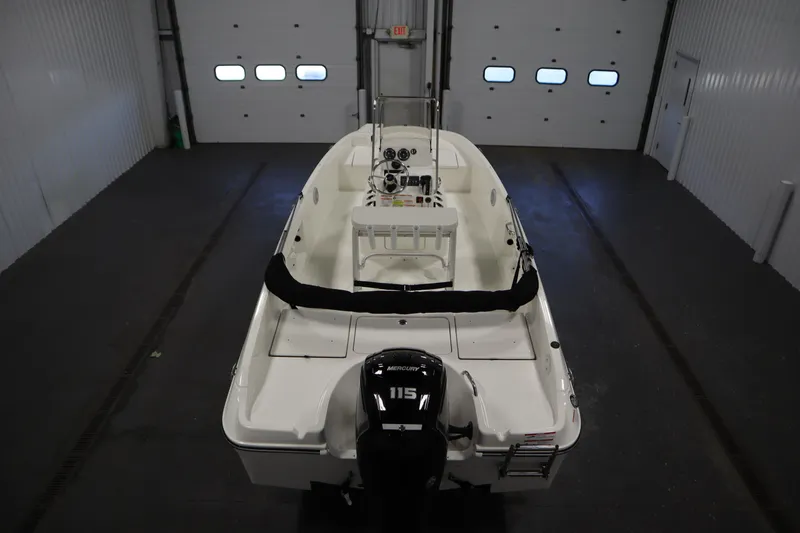 Slide: The Image of 2026 Bayliner Trophy T18 boat in a garage, featuring a Mercury 115 outboard motor. - 9