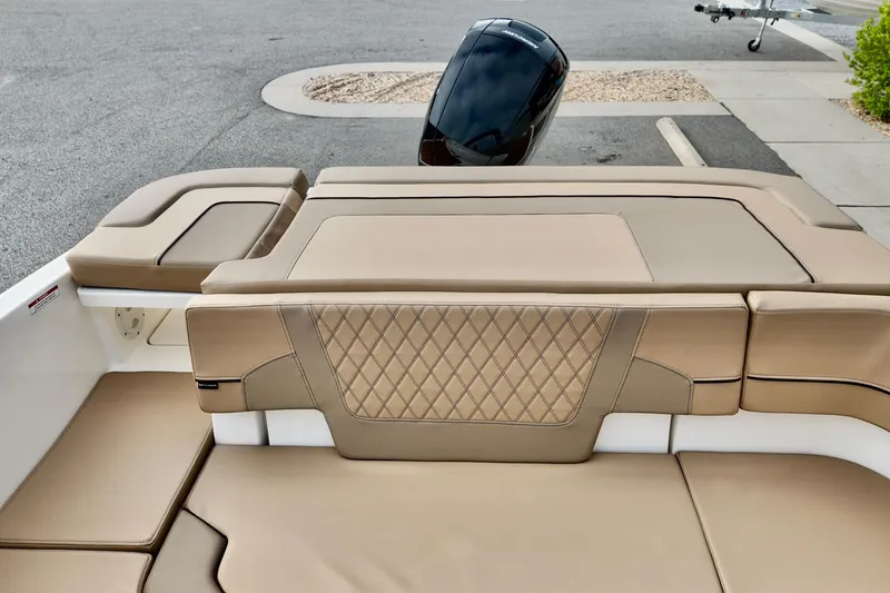 Slide: The Image of 2026 Bayliner VR6 boat with tan leather seating and outboard motor. - 10