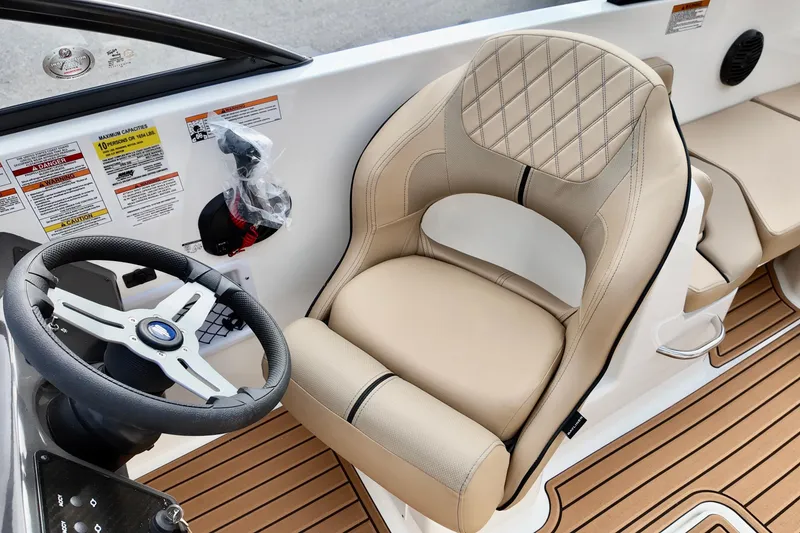 Slide: The Image of 2026 Bayliner VR6 boat interior with beige captain's seat and steering wheel. - 13