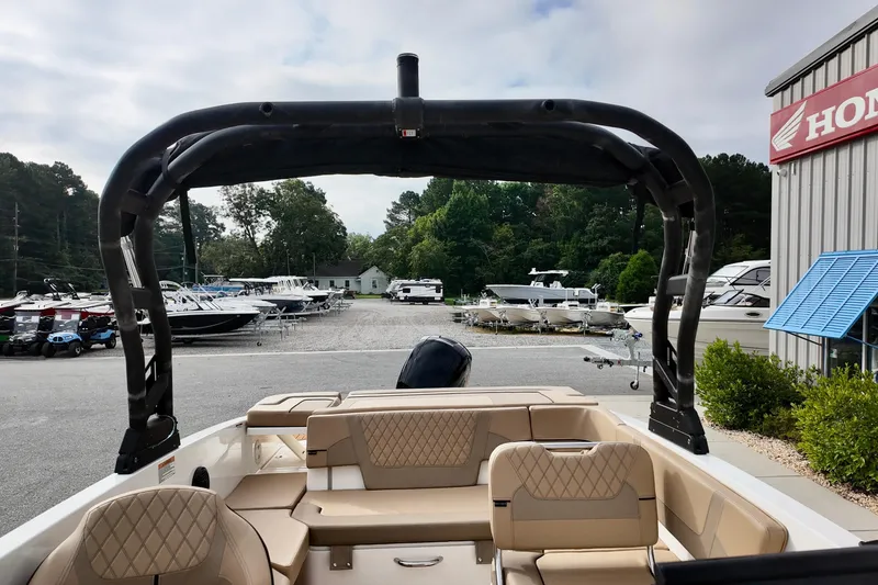 Slide: The Image of 2026 Bayliner VR6 boat interior at dealership, showcasing seating and arch design. - 15