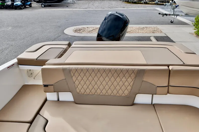 Slide: The Image of 2026 Bayliner VR6 boat with tan leather seating and outboard motor. - 16