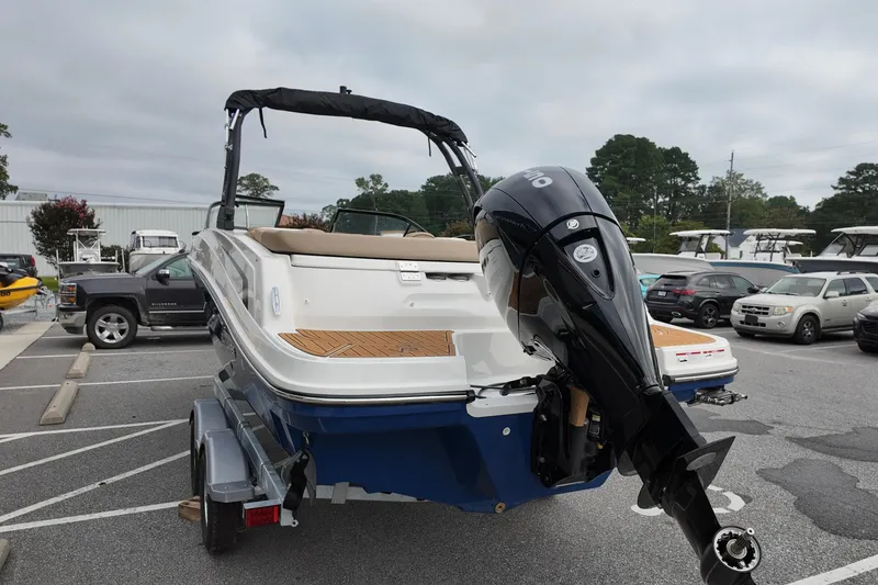 Slide: The Image of 2026 Bayliner VR6 boat on trailer, featuring sleek design and powerful outboard motor. - 4