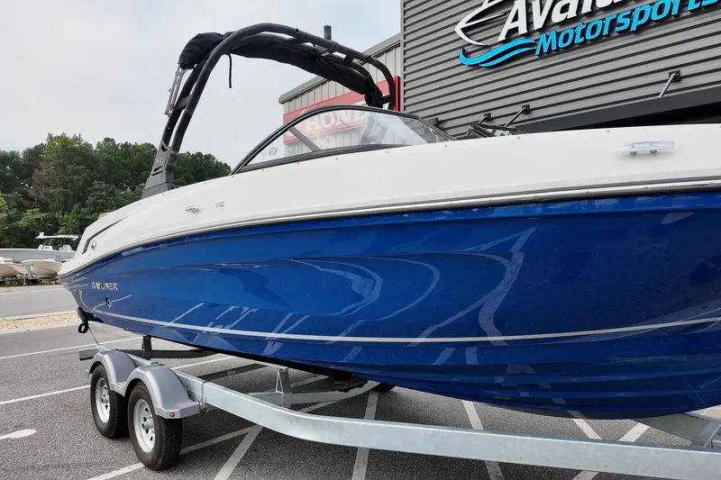Slide: The Image of 2026 Bayliner VR6 boat on trailer at dealership, featuring sleek blue and white design. - 5