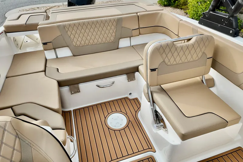 Slide: The Image of Luxurious interior of 2026 Bayliner VR6 boat with tan seating and wood flooring. - 8