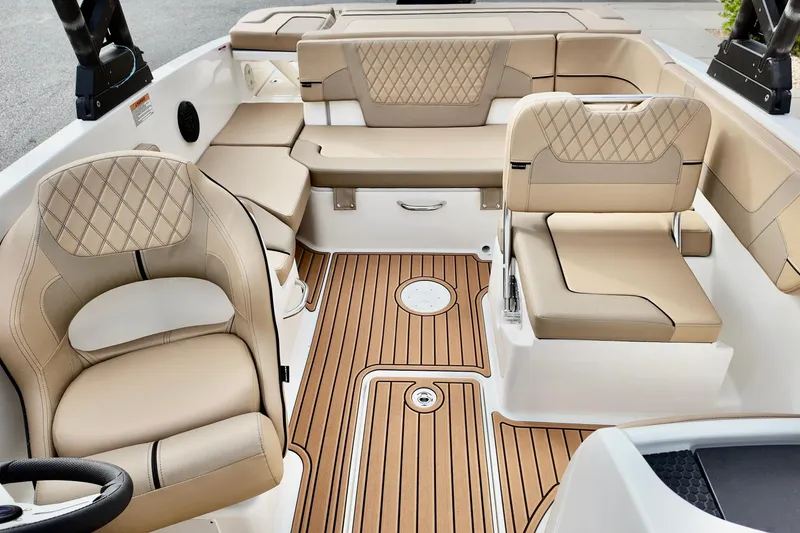 Slide: The Image of 2026 Bayliner VR6 boat interior with beige seating and wood-patterned flooring. - 9
