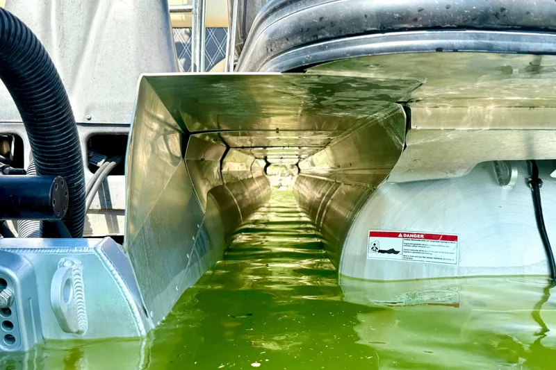 Slide: The Image of Underwater view of 2021 Barletta L25UC pontoon boat hull in green water. - 12