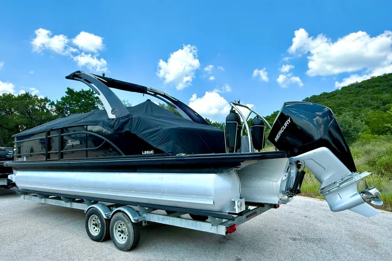 Slide: The Image of 2021 Barletta L25UC pontoon boat on trailer, covered, with Mercury outboard motor. - 16