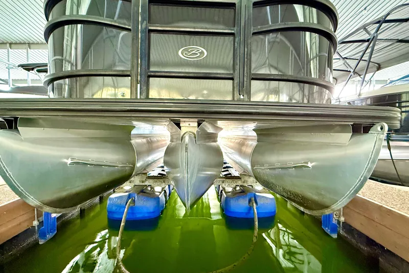 Slide: The Image of 2021 Barletta L25UC pontoon boat docked in a marina. - 23