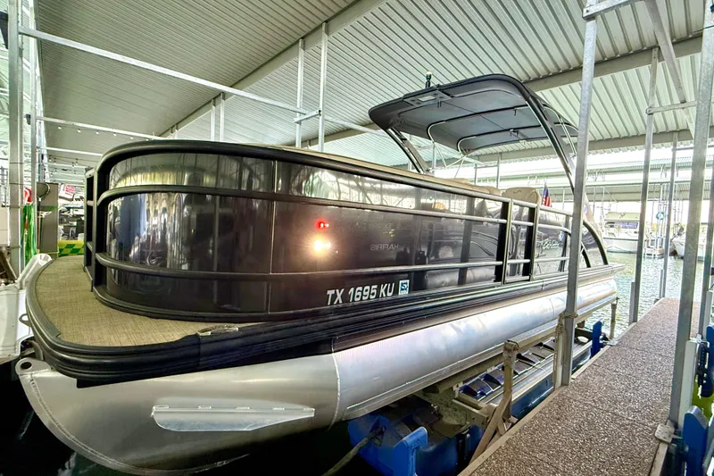 Slide: The Image of 2021 Barletta L25UC pontoon boat docked in a covered marina. - 24