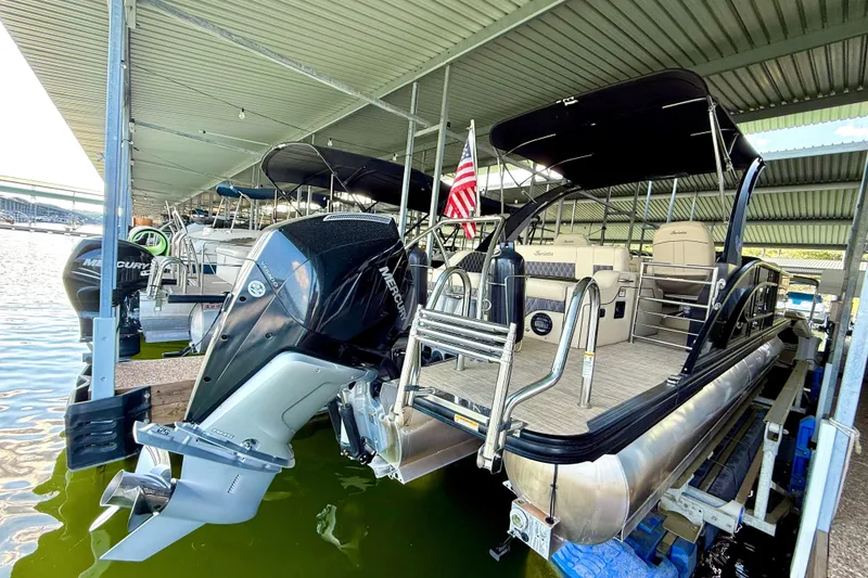 Slide: The Image of 2021 Barletta L25UC pontoon boat docked with Mercury outboard motor. - 26