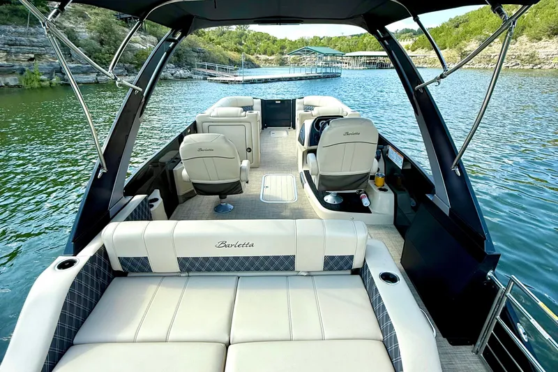 Slide: The Image of 2021 Barletta L25UC pontoon boat interior on a scenic lake. - 29