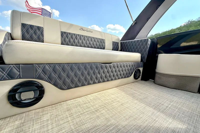 Slide: The Image of 2021 Barletta L25UC boat interior with quilted seats and American flag. - 31