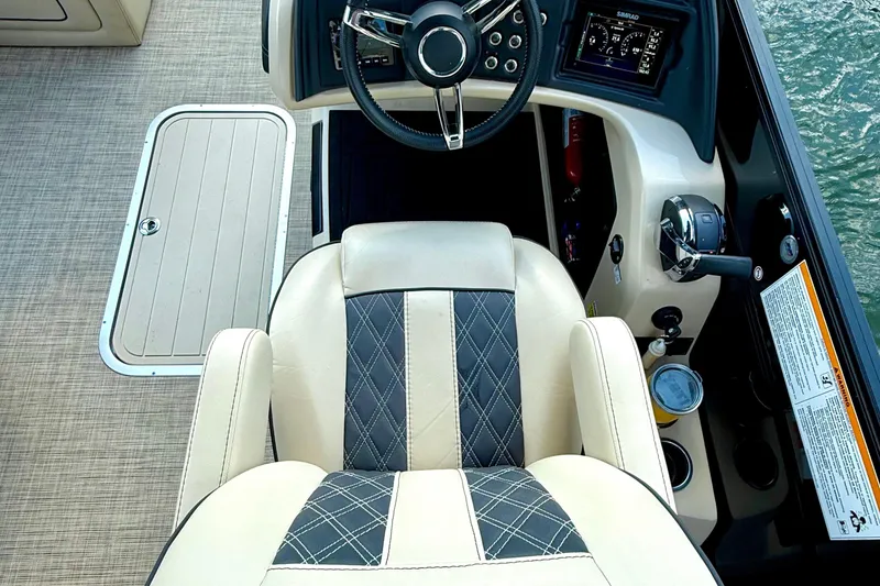 Slide: The Image of 2021 Barletta L25UC boat cockpit with steering wheel and control panel. - 34