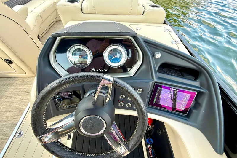 Slide: The Image of 2021 Barletta L25UC boat dashboard with steering wheel and navigation display. - 37
