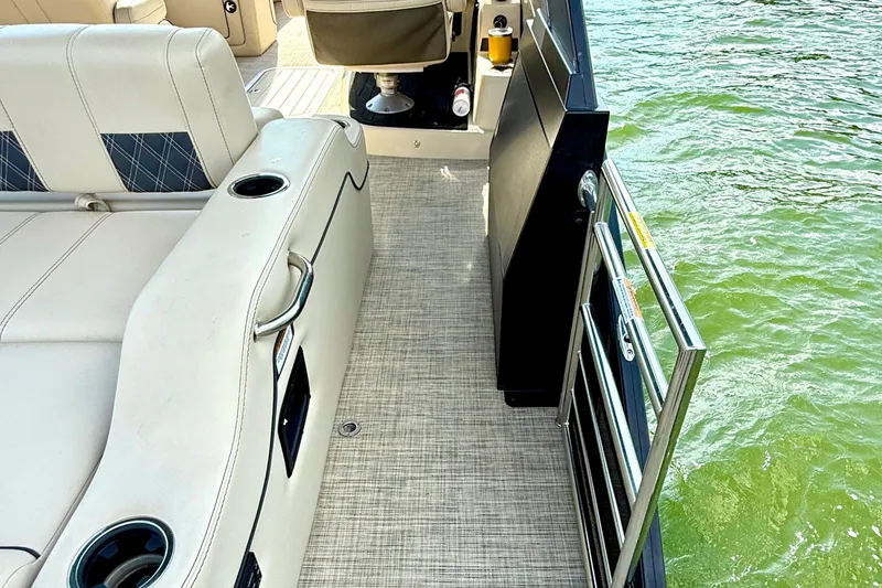 Slide: The Image of 2021 Barletta L25UC pontoon boat interior with seating and water view. - 40