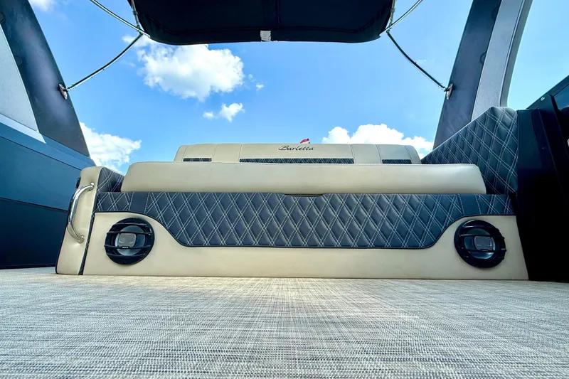 Slide: The Image of 2021 Barletta L25UC boat interior with luxurious seating and blue sky background. - 42