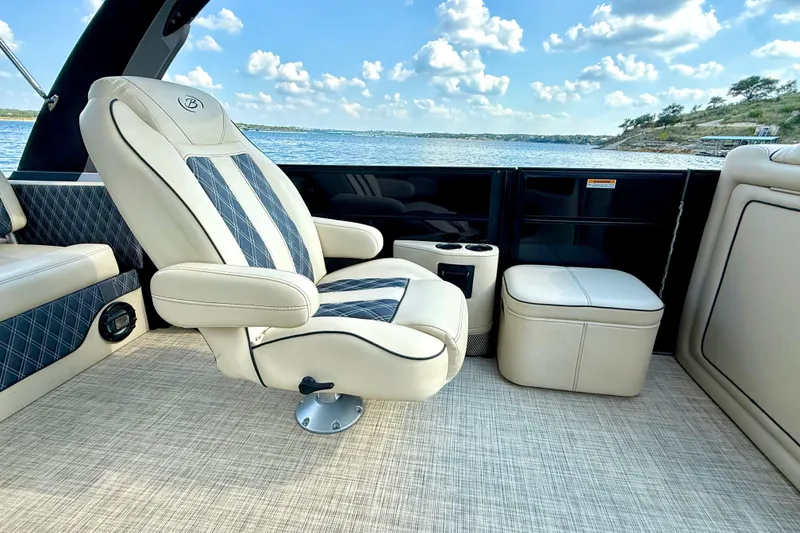 Slide: The Image of Luxurious interior of 2021 Barletta L25UC boat with plush seating and scenic lake view. - 43