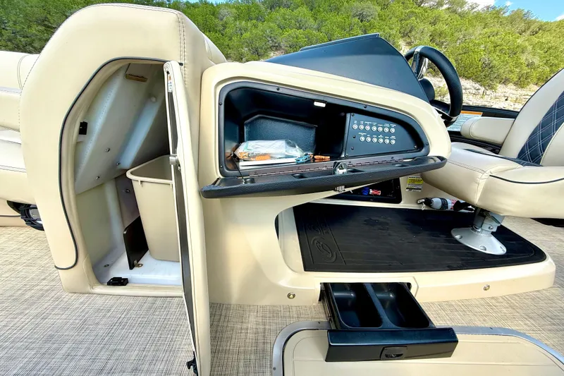 Slide: The Image of 2021 Barletta L25UC boat interior with storage compartments and control panel. - 49