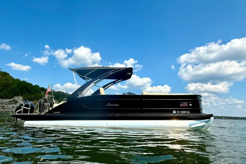 Slide: The Image of 2021 Barletta L25UC pontoon boat on a sunny lake with blue sky. - 5