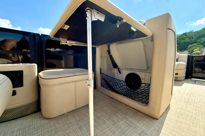 Slide: The Image of 2021 Barletta L25UC boat interior with under-seat storage and beige upholstery. - 51