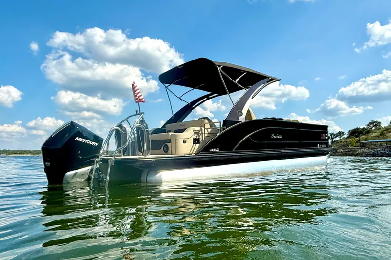 Slide: The Image of 2021 Barletta L25UC pontoon boat on a sunny lake with blue sky. - 7