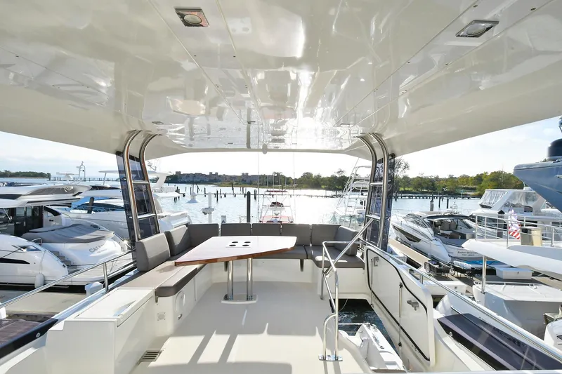 Slide: The Image of Luxurious 2018 Prestige 560 Fly yacht interior with spacious seating and scenic marina view. - 10