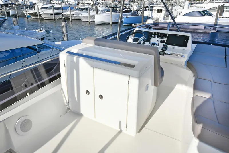 Slide: The Image of Flybridge of 2018 Prestige 560 Fly yacht with helm station and marina view. - 13