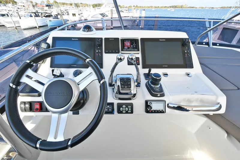 Slide: The Image of Helm of 2018 Prestige 560 Fly yacht with modern navigation equipment and steering wheel. - 18