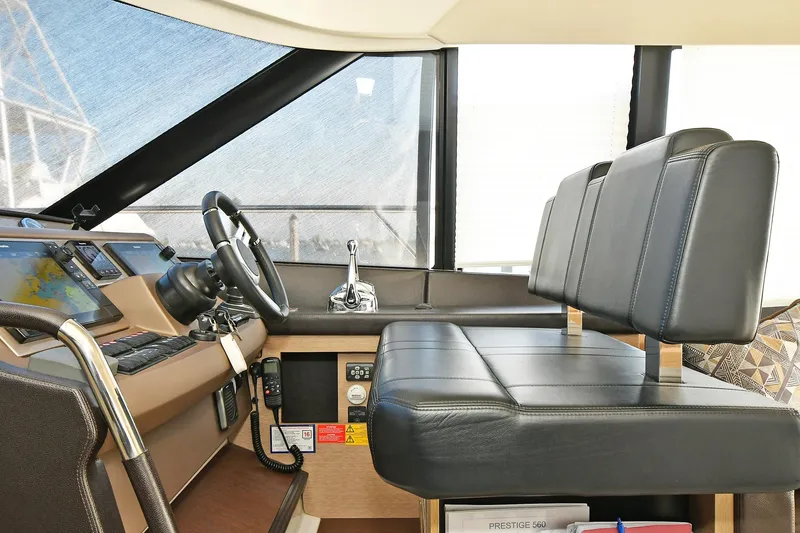 Slide: The Image of Interior helm of 2018 Prestige 560 Fly yacht with leather seating and modern controls. - 27