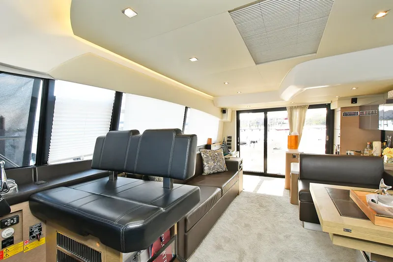 Slide: The Image of Luxurious interior of 2018 Prestige 560 Fly yacht with modern seating and large windows. - 29