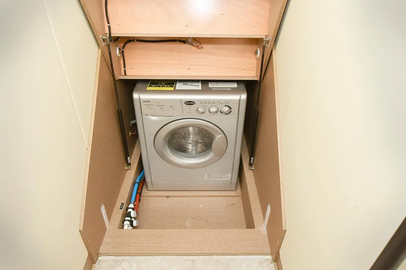 Slide: The Image of Compact washing machine in a 2018 Prestige 560 Fly yacht interior compartment. - 34