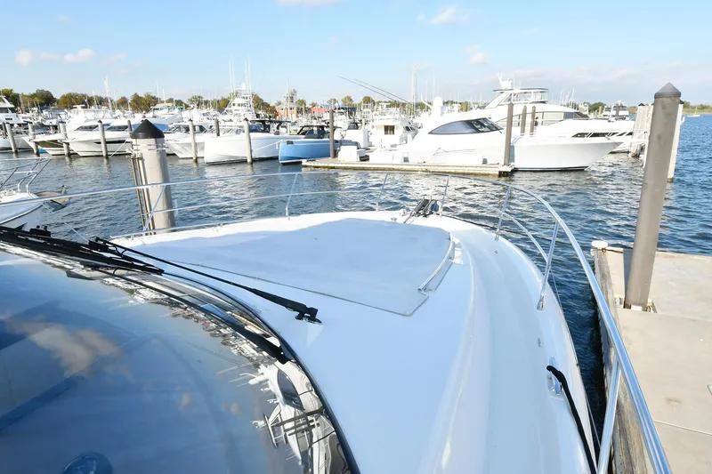 Slide: The Image of Prestige 560 Fly 2018 yacht docked at marina with other boats in background. - 4
